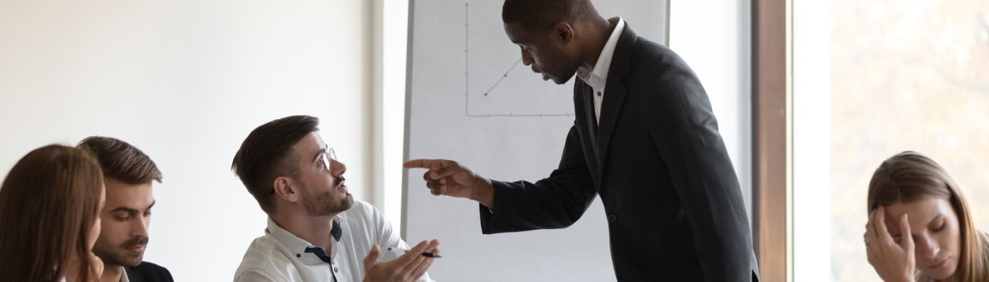 Multi-ethnic business partners having conflict accuse each other at group meeting in boardroom unpleasant situation caused by personal dislike, racial discrimination, struggle for leadership concept