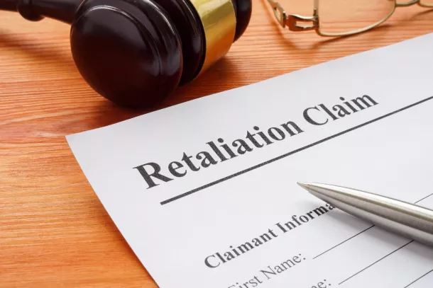 Retaliation claim lying on the desk with gavel