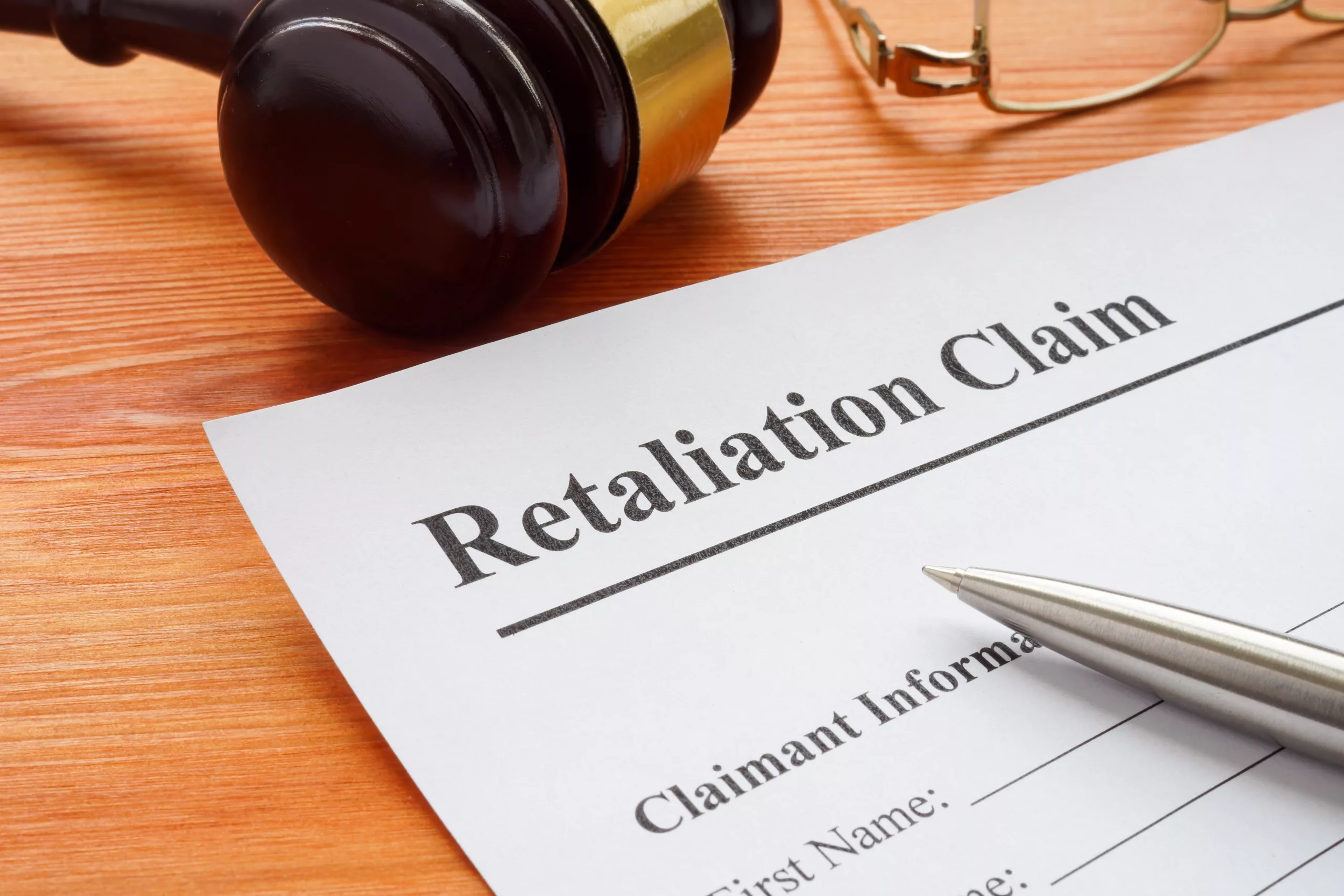 Retaliation claim lying on the desk with gavel.