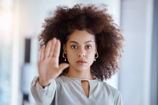 Hands, hr and manager stop sign with hand in office, serious, power and change in corporate. Black woman fighting sexual harassment, discrimination and toxic work environment with employee protection.